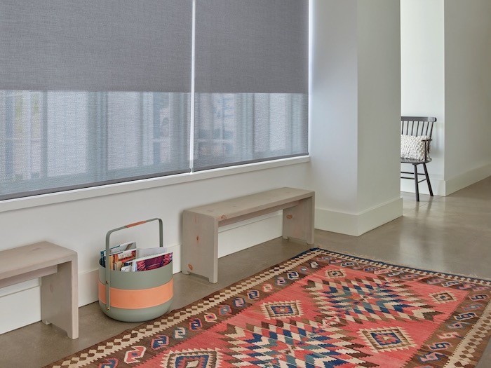 A hallway with a low-pile, colorful rug.